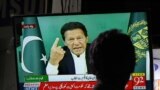 PAKISTAN -- A man watches a televised speech by Pakistan Prime Minister Imran Khan regarding the Senate elections, in Karachi, March 4, 2021