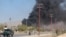 FILE: Smoke rises from the site of an attack in Gardez, the capital of southeastern Paktia Province.