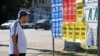 A man stands views campaign posters ahead of the upcoming parliamentary elections in Moldova, in Chisinau on September 21.