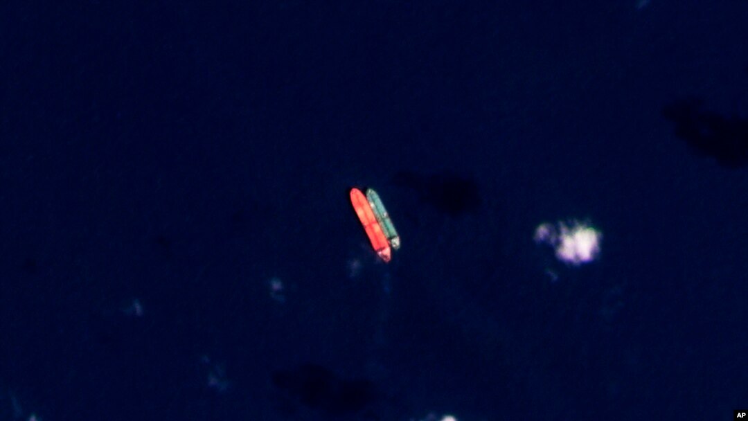 In this satellite photo provided by Planet Labs, vessels identified as the Virgo, left, and the Suez Rajan are seen in the South China Sea on February 13, 2022.