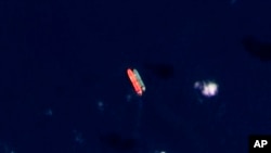 In this satellite photo provided by Planet Labs, vessels identified as the Virgo, left, and the Suez Rajan are seen in the South China Sea on February 13, 2022.