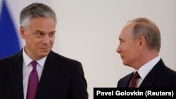 Russian President Vladimir Putin (right) and the new U.S. ambassador to Russia, Jon Huntsman, after receiving his diplomatic credentials during a ceremony at the Kremlin in Moscow on October 3.