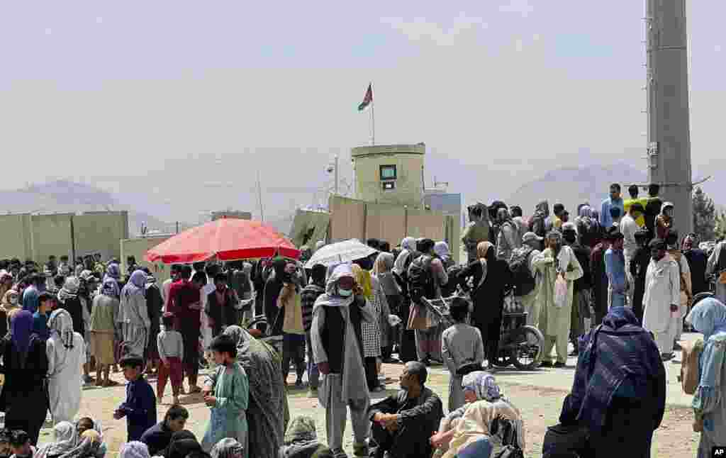 Hundreds of people gather outside the international airport in Kabul.