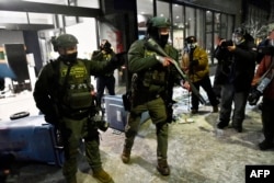 Федеральные агенты во время массовых акций протеста в Миннеаполисе в январе этого года