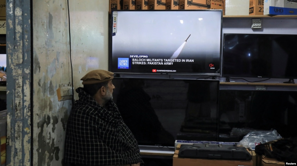A man in Peshawar, Pakistan, watches news in a shop after the Foreign Ministry announced the country had conducted air strikes inside Iran targeting separatist militants on January 18.