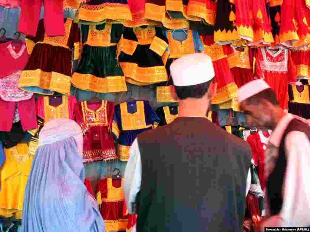 A shopkeeper waits on customers at a Kabul market.