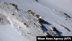 The wreckage of a plane that crashed near a mountain peak in Iran's Zagros mountain range, February 20, 2018