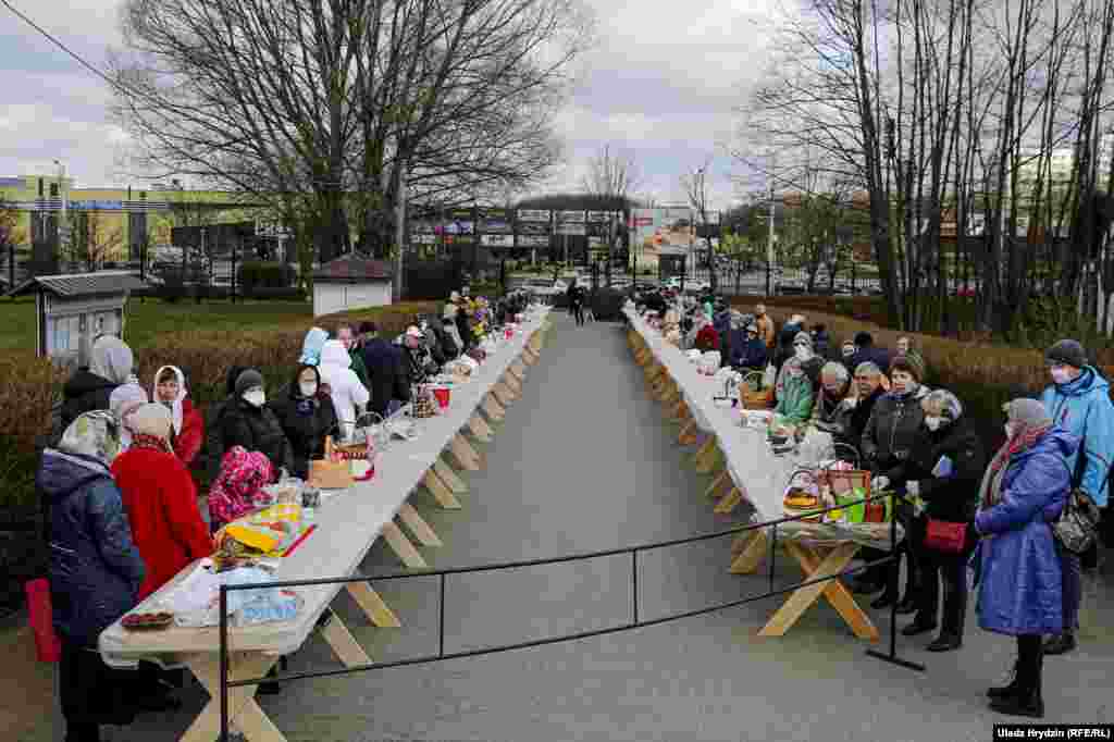 Parishioners with their &quot;paskha&quot; cakes, eggs, and other food gather at a church in Minsk on the eve of Orthodox Easter on April 18.