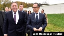 U.S. Secretary of State Mike Pompeo (left) and German Foreign Minister Heiko Maas walk along remains of the wall at a memorial site during their visit to the village of Moedlareuth near Hof, Germany, on November 7.