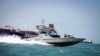 A boat of the Iranian Revolutionary Guard sails near to Stena Impero, a British-flagged vessel owned by Stena Bulk, in Iranian waters, August 22, 2019