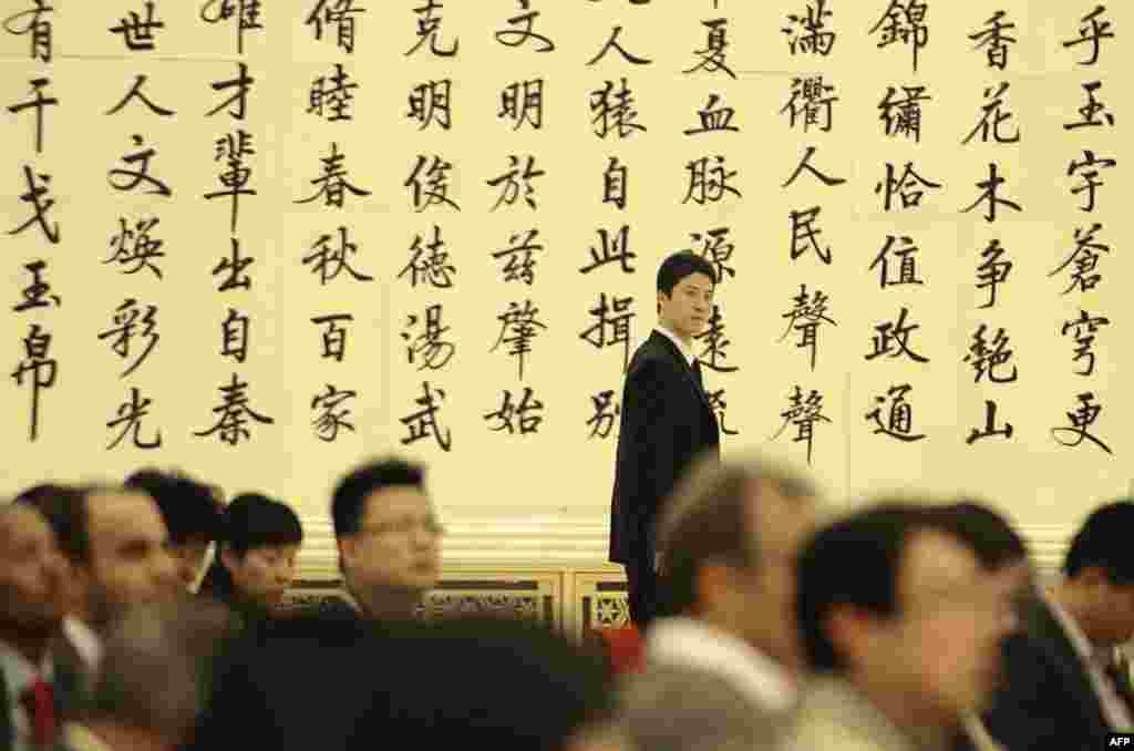 A staff member walks around the Great Hall of People during a press conference in Beijing.