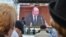 Prime Minister Valeriu Strelet is seen on a screen outside the parliament building in Chisinau as he speaks inside shortly before he was dismissed on October 29.