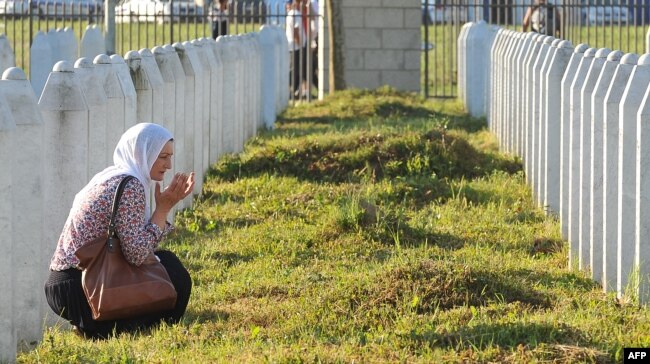 A Bosnian Muslim woman and survivor of the Srebrenica massacre, mourns near graves of her relatives at a memorial cemetery in eastern Bosnia. (file photo)