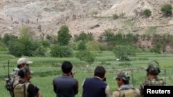 Afghan Special Forces monitor the site where a massive U.S. bomb was used against militants in the eastern province of Nangarhar.