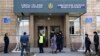 Police stand at the entrance to the Almaty Fashion Design College following the blast.