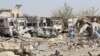 Damaged vehicles are seen at the site of a car bombing in Qalat, capital of Zabul Province, on September 19.