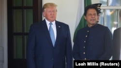 FILE: U.S. President Donald Trump talks with Pakistani Prime Minister Imran Khan as he arrives for meetings at the White House on July 22.