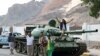 YEMEN -- Southern Yemeni separatists stand by a tank in the port city of Aden, January 30, 2018