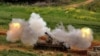 An Israeli self-propelled howitzer artillery gun fires toward southern Lebanon from a position in northern Israel on March 26.