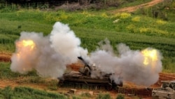An Israeli self-propelled howitzer artillery gun fires toward southern Lebanon from a position in northern Israel on March 26.