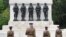 British military officers observe two minutes of silence to commemorate Victory in Europe Day at the Guards memorial in London in 2020.