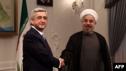 Iran -- Armenian President Serzh Sarkisian (L) meets with Iran's new President Hasan Rohani (R) at his office in Tehran on August 5, 2013.