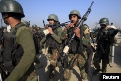 Pakistani Army soldiers assemble outside Bacha Khan University.