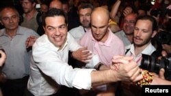 The head of Greece's Left Coalition party, Alexis Tsipras, celebrates with supporters in Athens on May 6. 