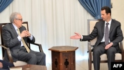 Syrian President Bashar al-Assad (right) meets with UN-Arab League peace envoy Lakhdar Brahimi in Damascus on October 30.