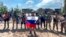 In a grab taken from video and released by Prigozhin Press Service on May 20, Yevgeny Prigozhin, head of the Wagner mercenary group, holds a Russian flag in front of his soldiers in Bakhmut, Ukraine. 