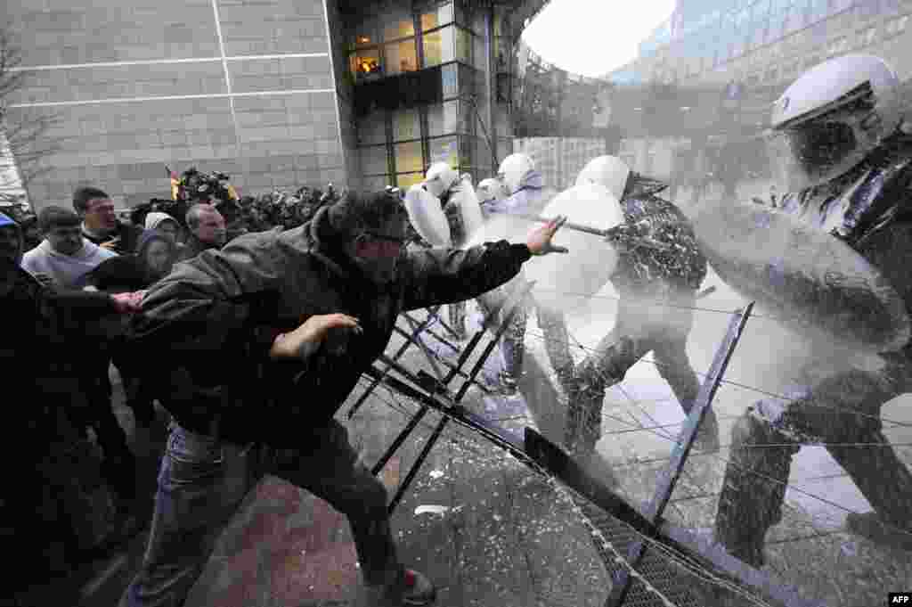 Dairy farmers confront police at Place du Luxembourg, near the European Parliament building in Brussels, in a protest against EU agricultural policies and falling milk prices. (AFP/John Thys)