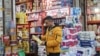 An Iranian man shops in a local market, as protests erupt over the collapse of the currency's value, in Tehran