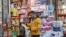 An Iranian man shops in a local market, as protests erupt over the collapse of the currency's value, in Tehran