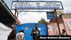 An Afghan policeman keeps watch outside of a hospital that came under attack in Kabul on May 13.