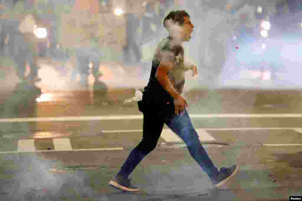 A man is hit with pepper-spray paintballs in Charlotte, North Carolina, during a protest against the fatal police shooting of Keith Scott. Police say Scott was holding a gun and had refused orders to drop his weapon. His family says he was holding a book. (Reuters/Jason Miczek)