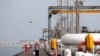 An Iranian worker walks the platform of the oil facility in the Khark Island, on the shore of the Persian Gulf.