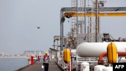 Iran -- An Iranian labourer walks the platform of the oil facility in the Khark Island, on the shore of the Gulf, March 12, 2017