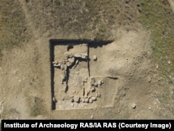 An excavated building on a rocky ridge near the Polyanka settlement in 2020.