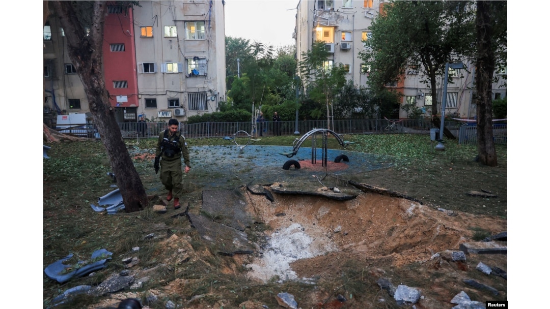 Israeli emergency services work at the scene of a missile strike that, according to Israel's military, was launched from Yemen and landed in Jaffa, Israel, on December 21.