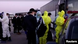 Uzbek citizens, mainly students, who were evacuated from China are seen after landing at Tashkent Airport on February 4.