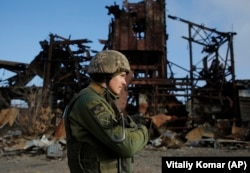 A Ukrainian soldier walks past the destroyed Butovka coal mine in the town of Avdiyivka in the Donetsk region.