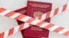 GENERIC – White and red warning tape over the two Russian passports