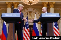 U.S. President Donald Trump (left) and Russia's President Vladimir Putin shake hands during a joint news conference after their controversial summit in Helsinki on July 16.