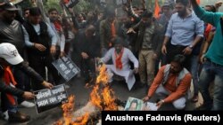 Activists from a right-wing Hindu group burn portraits of Pakistani Prime Minister Imran Khan as tensions rise between India and Pakistan.