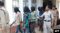 Police officers escort gang-rape suspects to court in Datia, in central Madhya Pradesh state, on March 18.