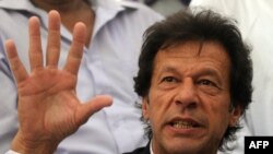 Pakistan -- Pakistan's opposition leader and fomer cricketer Imran Khan gestures at a press conference in Karachi, 20May2011