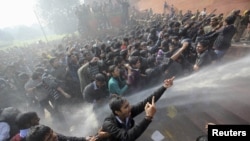 India -- Demonstrators shout slogans as police use water cannons to disperse them near the presidential palace during a protest rally in New Delhi, 22Dec2012