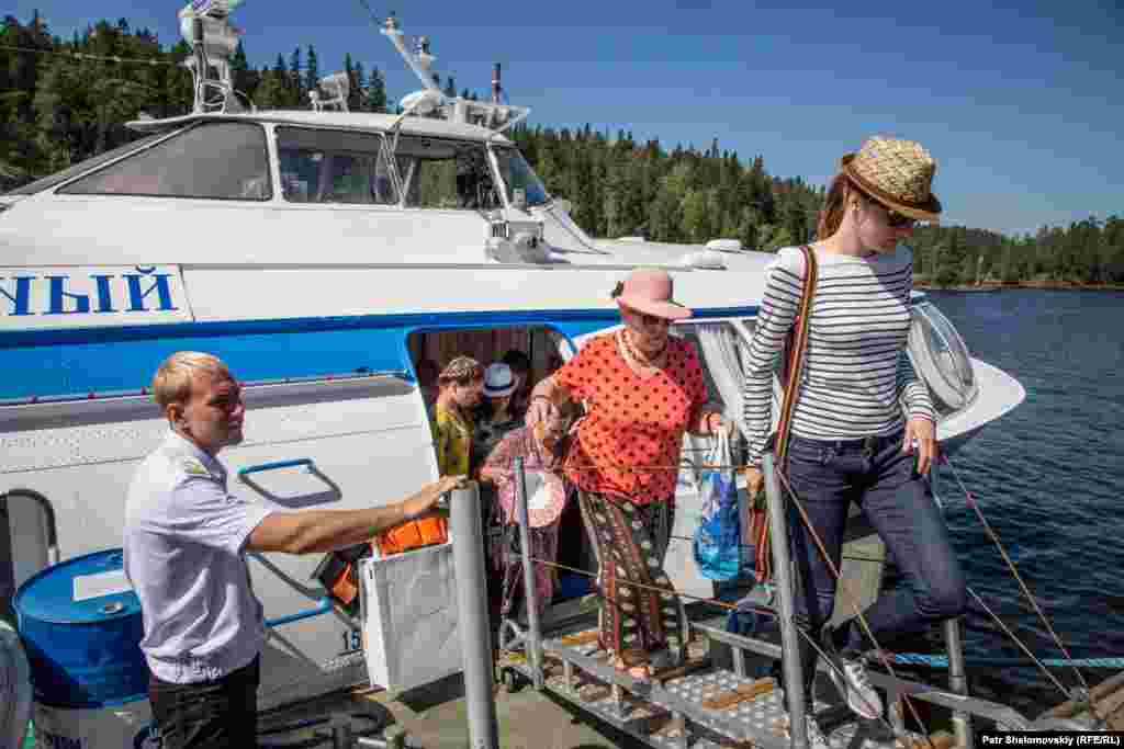 Visitors arrive on the island by speedboat.