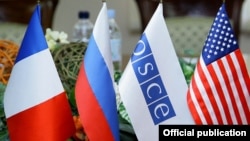 Armenia - Flags of the OSCE and the three nations co-chairing the OSCE's Minsk Group displayed during peace talks in Yerevan, 4Feb2014.