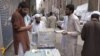 Members of Jammat-ud Dawa selling their newspaper and raising funds in Peshawar.